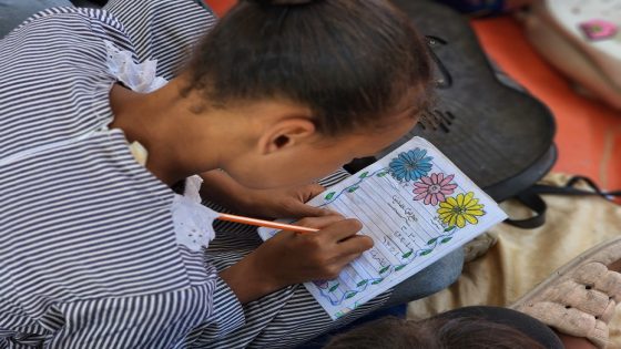 Teacher from Gaza teaches students in the tent school