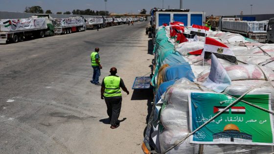 Trucks carrying humanitarian aid line up near the Rafah border crossing, in Rafah