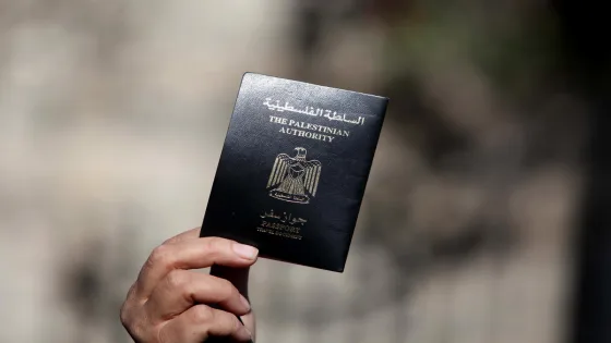 A Palestinian woman holds her passport during a protest demanding for the opening of Rafah crossing border in front of the headquarters of the Council of Ministers in Gaza city, on December 31, 2014. Photo by Ashraf Amra